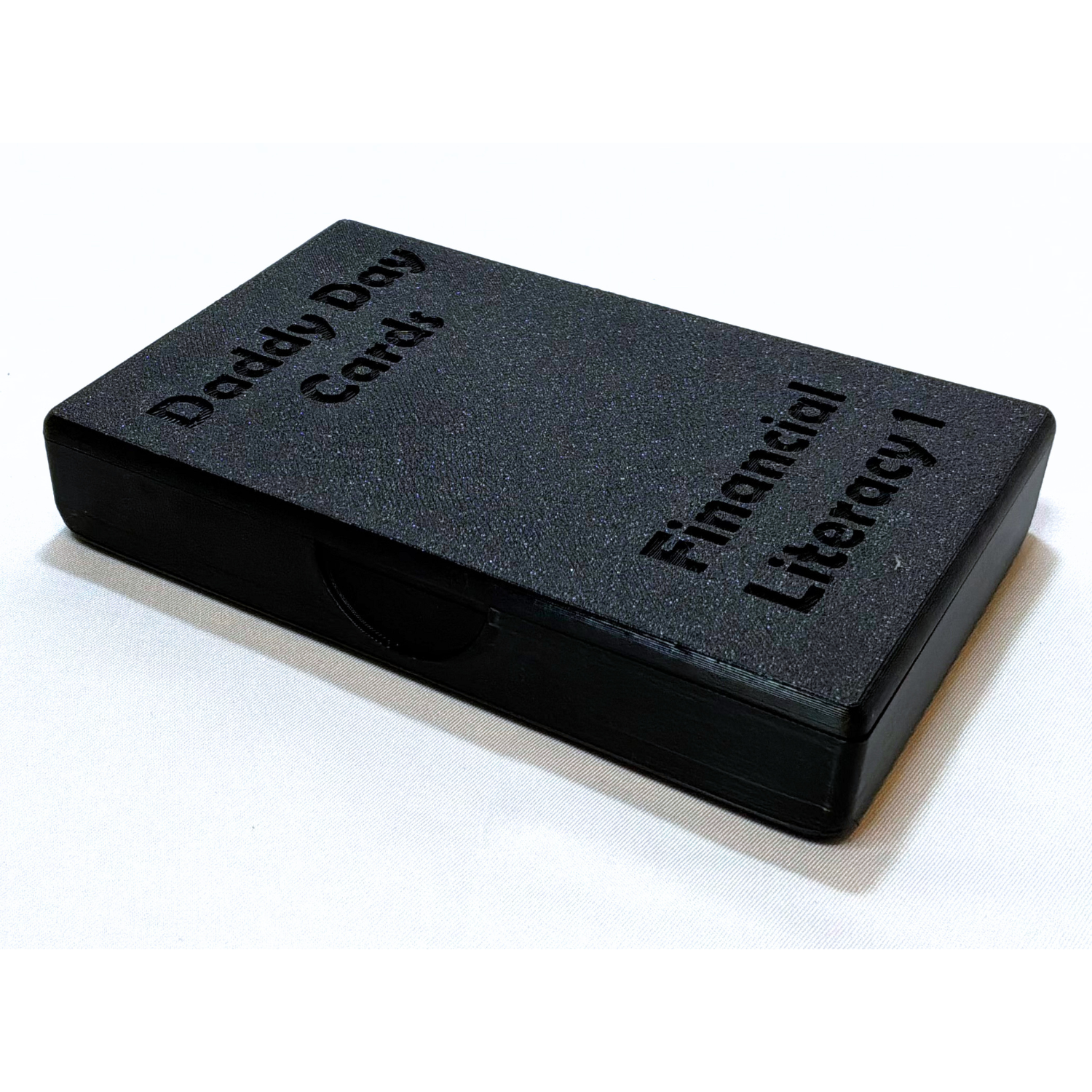 Black box with 'Daddy Day Cards' and 'Financial Literacy 1' text on a white background
